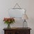 Stunning Art Deco mirror from France, 1930s. Beveled mirror secured to a wooden back. Mirror hangs from vintage metal...