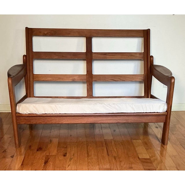 High-quality, Vintage Danish Mid-Century Modern solid teak wood frame deep two-seat loveseat. This piece features...