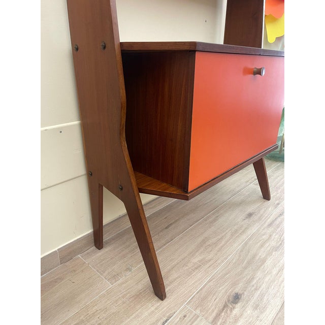 Single-span bookcase with shelves and cabinet with drop-leaf door, 1960s. The design of this teak bookcase recalls the...