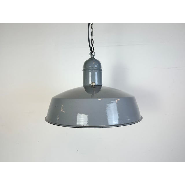 Industrial grey enamel factory pendant light made in Netherlands during the 1960s. White enamel inside the shade. Iron...