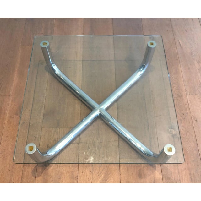 This coffee table is made of a chrome base with a glass shelf. This is a French Work. Circa 1970.