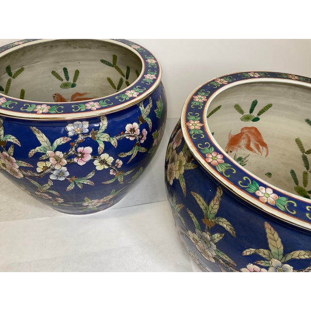 This is a wonderful pair of Vintage Chinese Koi Fish Porcelain Jardiniere Blue with Floral Planter Fish Bowl . The fish...