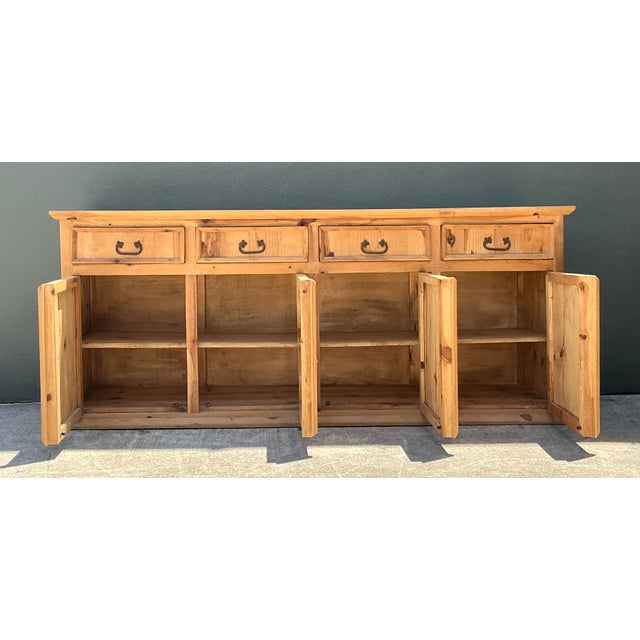 This impressive vintage credenza is a celebration of rustic warmth and grand-scale functionality. Masterfully crafted from...
