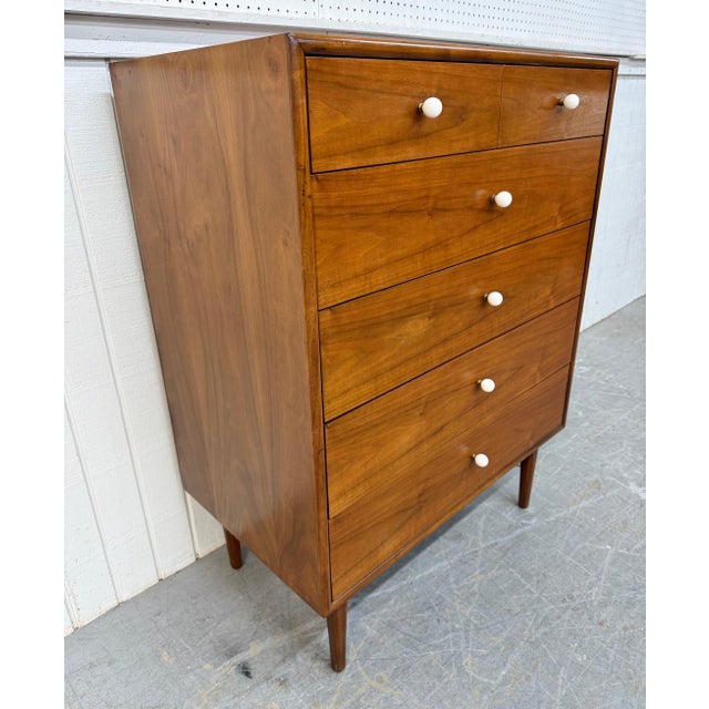 This striking Mid-Century Modern Drexel Declaration high chest is a true icon of American modern design. Crafted in...