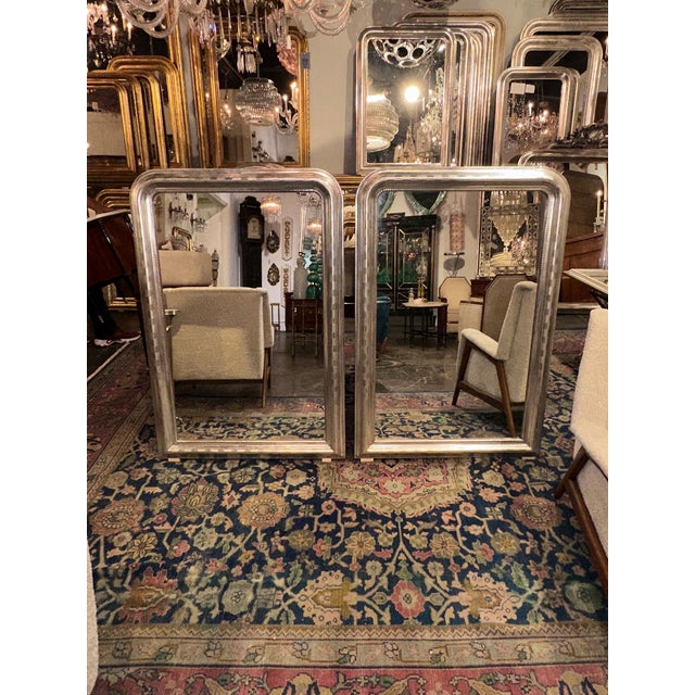 The product is a pair of French Louis Philippe silver mirrors, adding a touch of elegance and sophistication to any home...