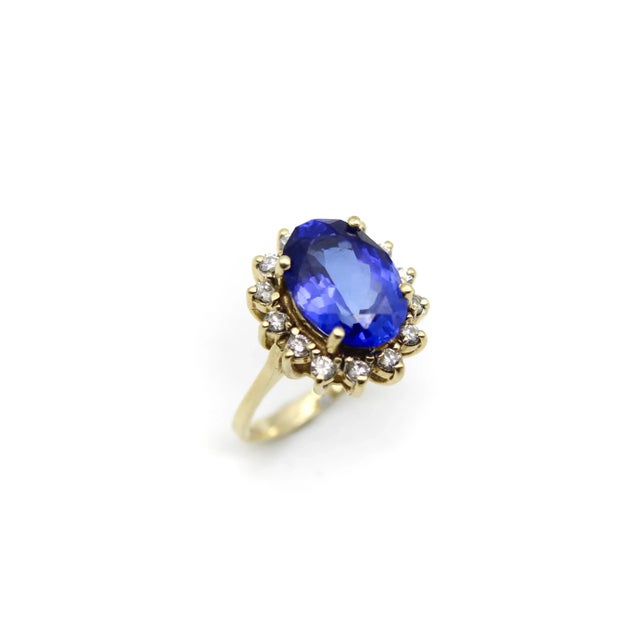 This is part of Chairish’s Fine Jewelry assortment. This beautiful vintage 14k gold ring features an oval tanzanite framed...