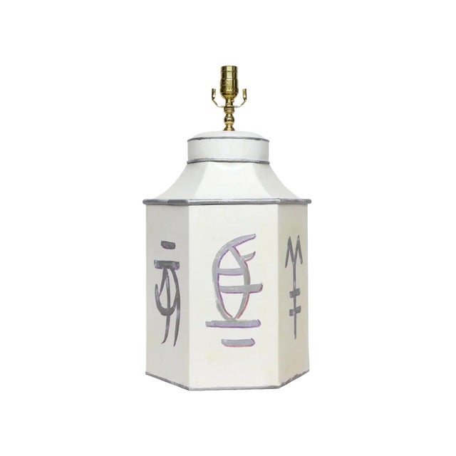 These late 20th-century hand-painted tin lamps cleverly blend geometric shapes with calligraphic charm. Based on the...