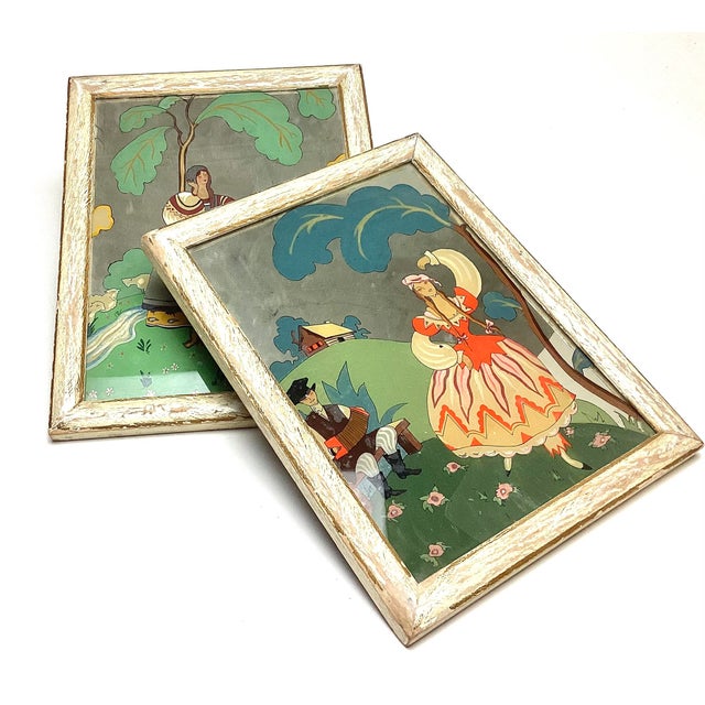 Pair of Art Deco Reverse-Painted Mirrors after Georges Barbier Elegant pair of Art Deco reverse-painted images on mirror,...