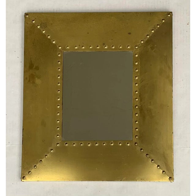 Striking brass clad rectangular mirror in the manner of Sarreid and Maitland Smith with brass nailhead stud details. Brass...