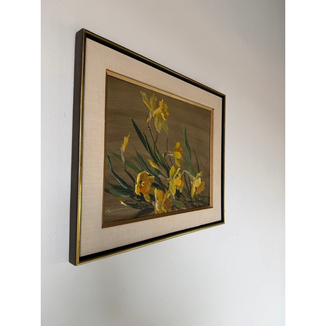 A charming 1970s floral still life oil on board painting by J. Schumacher, depicting a loose arrangement of vibrant yellow...