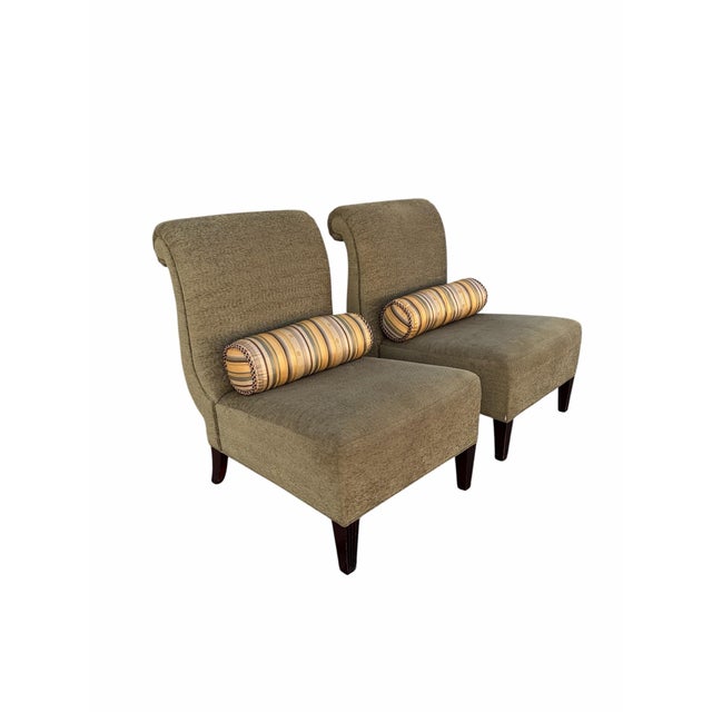 Offered here is a pair of slipper chairs designed by Barbara Barry for Baker Furniture. Each chair has a sleek, scroll...