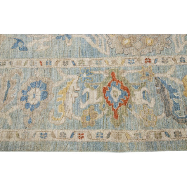 Beautiful modern Sultanabad hand-knotted wool rug with a blue color field. This rug has a designed frame with beige,...
