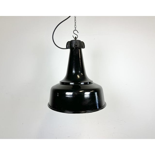 Industrial iron black painted pendant light made by in former Czechoslovakia during the 1970s. White inside the shade....