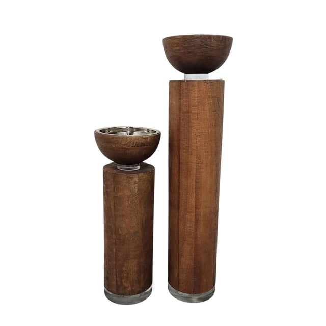 From luxury home décor brand Global Views, this set of two substantial pillar candle holders blends warm mango wood with...