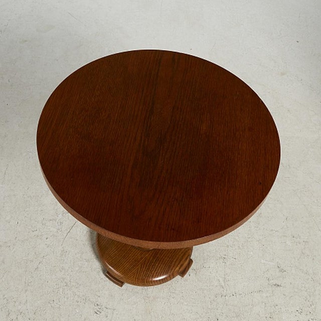 This Swedish Functionalist pedestal table from the 1940s features a round oak top supported by a central turned column...