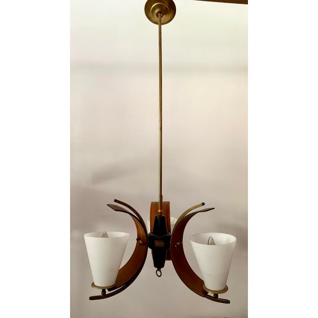Here is a stunning 3-light chandelier from the mid-century in the Stilnovo, Italian style featuring a combination of...