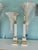 A striking pair of neoclassical-inspired table lamps featuring elegant fluted column forms, embodying the timeless glamour...