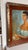 This mid-century portrait depicts a Spanish woman in a ruffled, off-the-shoulder mint green dress. She features an...