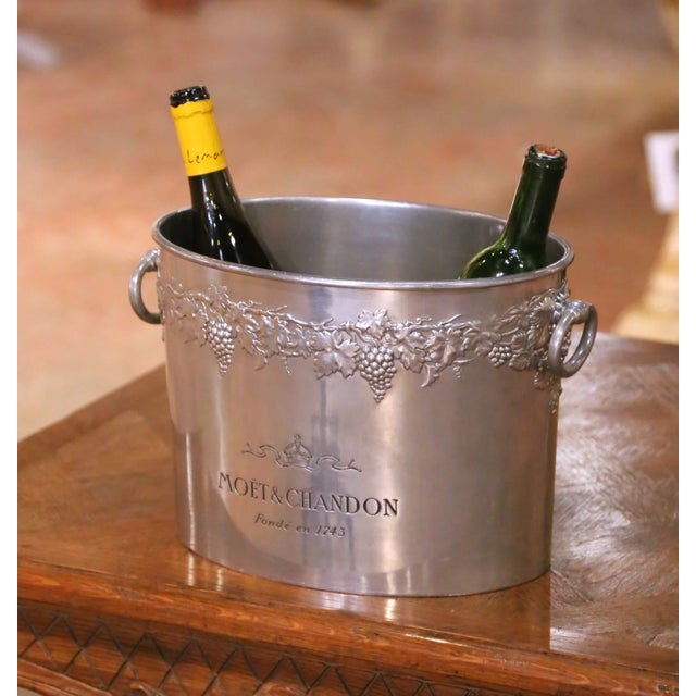 This antique French champagne cooler, crafted in pewter with a soft silvered finish circa 1920, was designed for both...