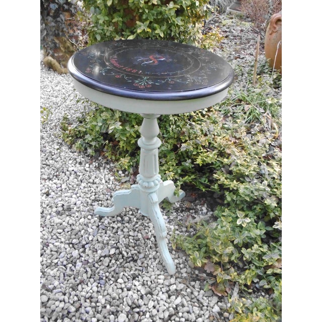 An antique wooden table from 1884, with an inlaid stone top bearing the date. Likely made for a wedding or birthday....