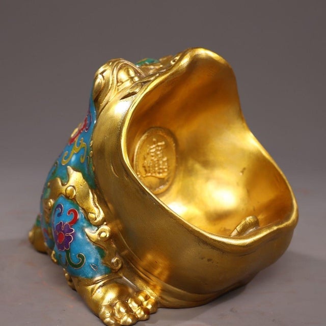 This charming vessel is modeled in the form of a large-mouthed toad (Jin Chan), a traditional symbol of wealth and...