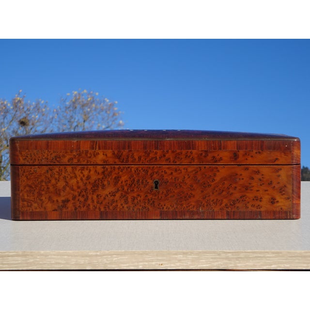 Beautiful jewelry box in thuya burl with straight wood marquetry, an ornate brass cartouche inlaid with a stone on the...