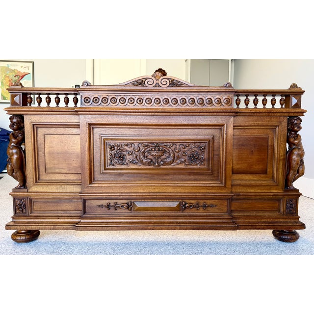 Mid 19th century French exquisitely carved walnut bed frame. Carved cherubs in the foot board are unique. This bed frame...