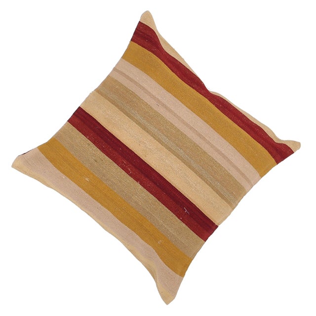 A one-of-a-kind handwoven wool kilim floor pillow featuring horizontal bold red and gold bands on cream. Fully reversible...