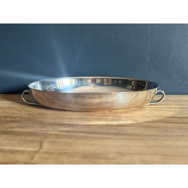 Oval silverplate vegetable dish with two cast handles. The body is plain. It was likely the base of a covered vegetable...