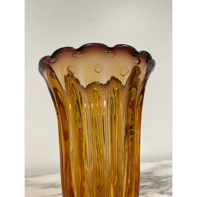 Whether displayed as a standalone art piece or used to hold vibrant floral arrangements, this Venetian glass vase becomes...