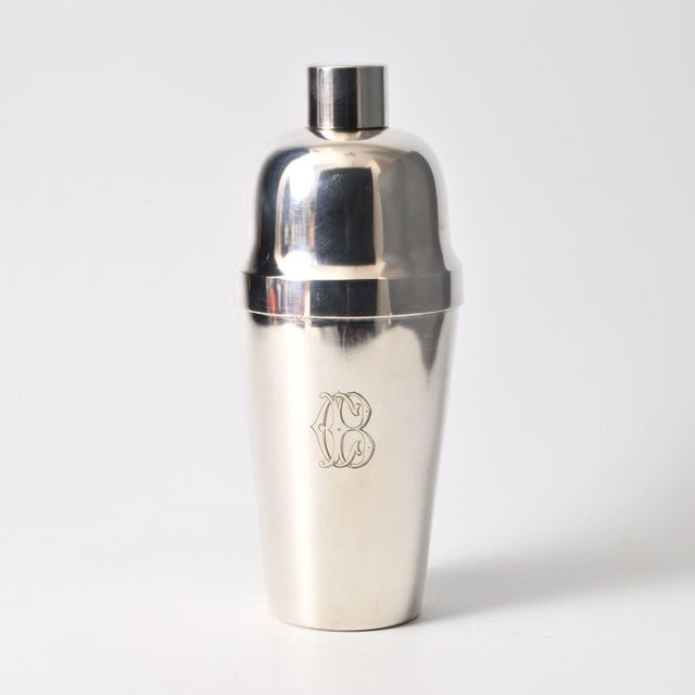Silver plated cocktail shaker from Orfevrerie Mills. Engraved monogram CB. Made in 1920s in Belgium. This piece has an...