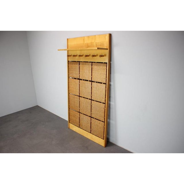 A distinctive mid-century modern wall-mounted coat rack designed by jan kalous for úluv (ústředí lidové umělecké výroby),...