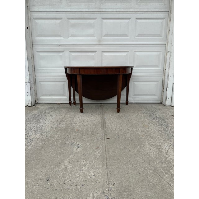 We have a beautiful vintage Federal Revival mahogany drop leaf dining table for sale! This classic gateleg table features...