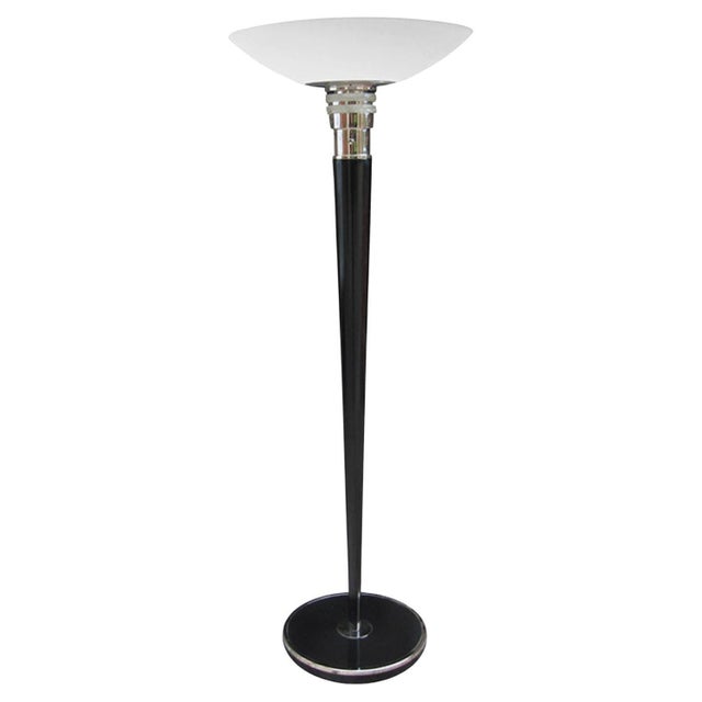 An Art Deco period torchere floor lamp designed by Jean Perzel from France circa 1930. The circular black lacquer stand...