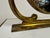 A mid-century Italian vanity mirror in brass, dating to the 1950s, with an elegant, neoclassical-inspired silhouette. The...