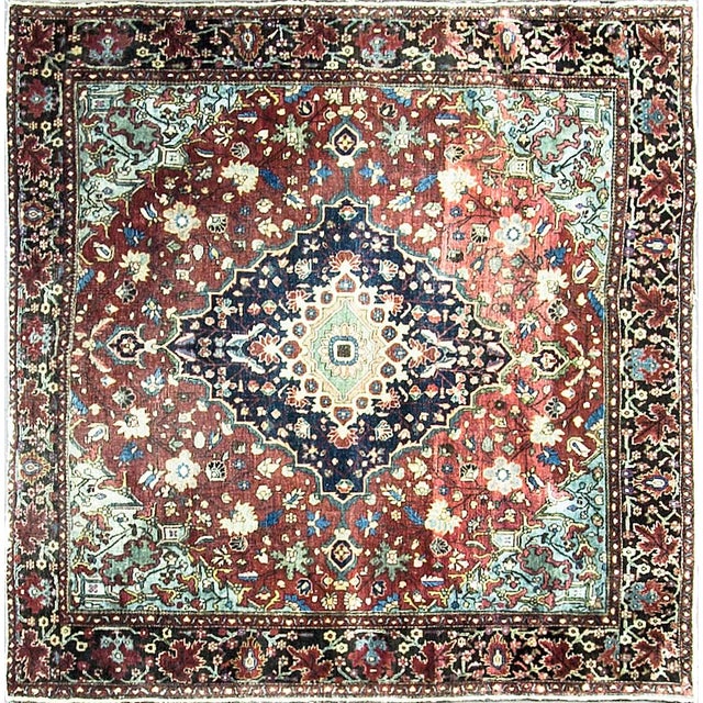 A beautiful antique Persian Feraghan Sarouk rug woven in an uncommon square format. The rug features a classic medallion...