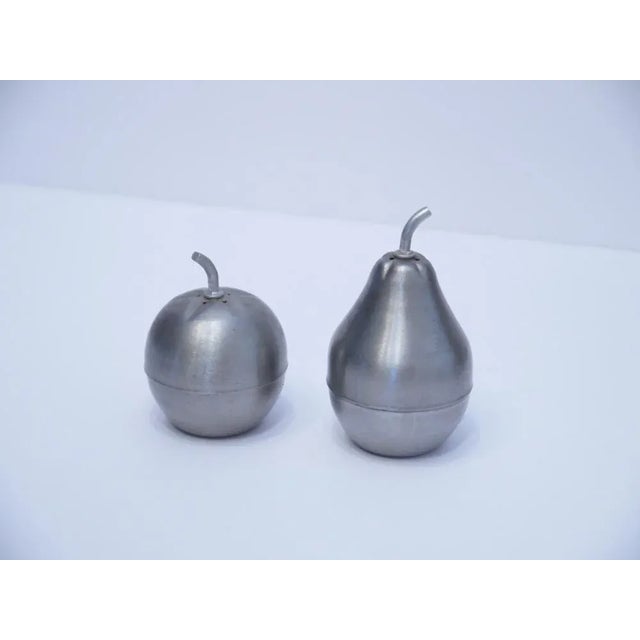 This is a cute 'pair' of salt and pepper shakers. The pear is the salt shaker and the apple is the pepper shaker, with an...