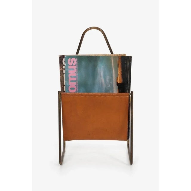 Carl Auböck brass and leather magazine rack, patined cognac leather and brass, model 3808 Note; strong patina and wear...