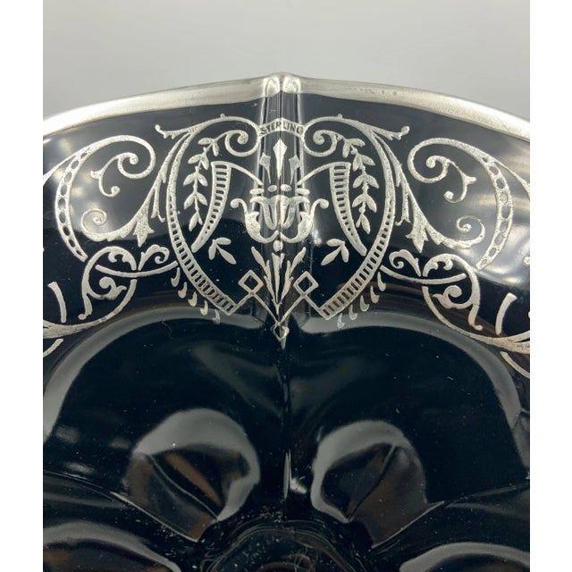 Large black amethyst glass bowl (almost 11" in diameter) has an interesting scalloped interior shape. The outside rim has...