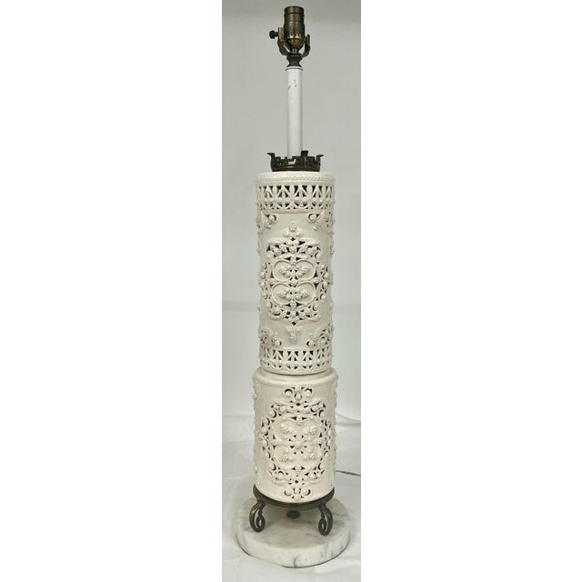 Beautiful tall chinoiserie style lamp. Two part pierced porcelain body , ornate brass and Carrara marble base.