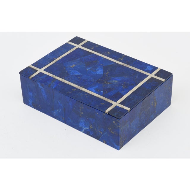 This mid century modern Lapis Lazuli 2 part box has silver inlay inserts with a quartz interior and bottom. It is from the...