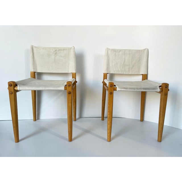 An elegant pair of "linda" chairs for zanotta, 1970. The solid wood frame features exposed joints and the seat and...