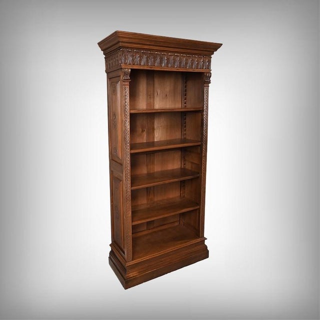 This small walnut bookcase, dating from the early 20th century, is topped with an elegant molded cornice and rests on a...