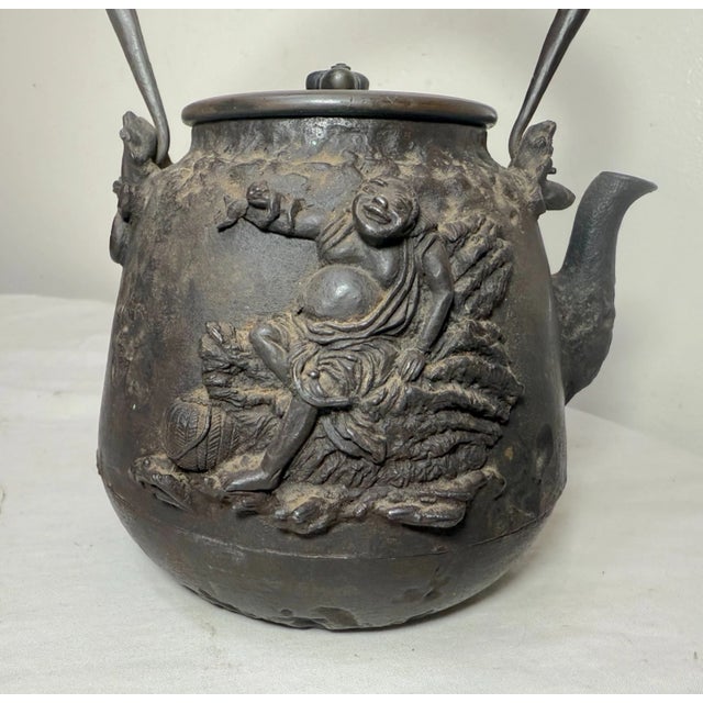 A tetsubin (iron kettle) and cover By Daikoku made for the Seijudo Company, Meiji era (1868-1912), late 19th/early 20th...