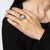 Stylish turquoise 'swirl' ring crafted in 14 karat rose gold. Cabochon cut turquoise measures 10mm. The distinct design...