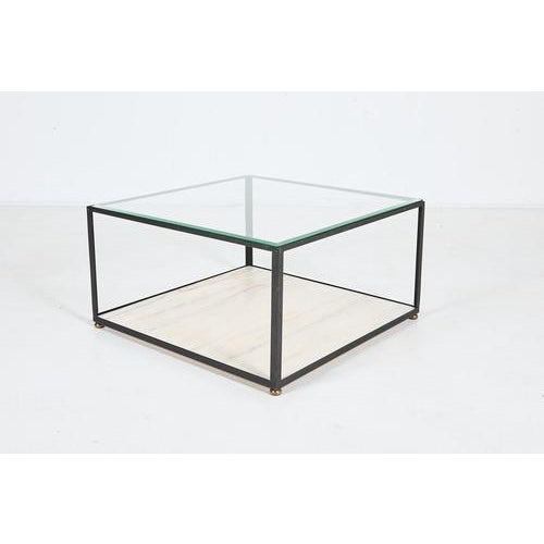 Architectural square coffee table from 1960s produced in Italy. Features black coated steel base with brass feet caps,...