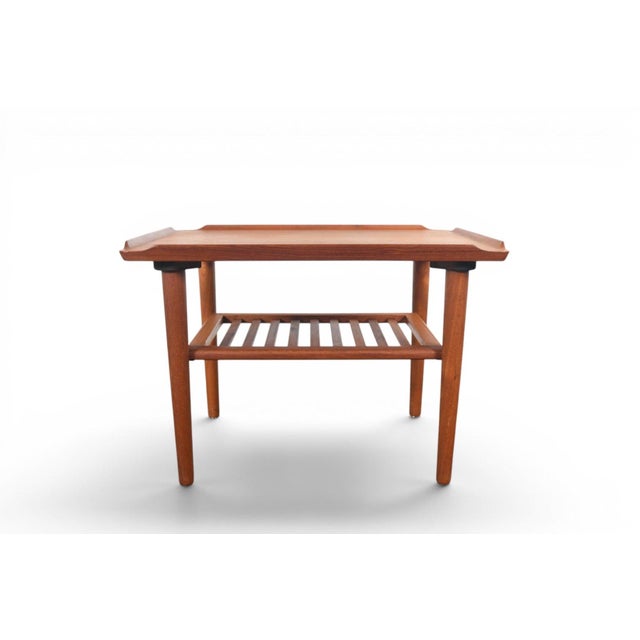 This side table was designed by Holger Georg Jensen and produced by Kubus in Denmark during the 1960s. The teak top sits...