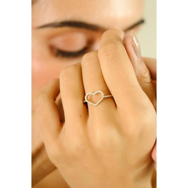 Crafted in lustrous 14k white gold, this exquisitely refined ring features a delicate heart-shaped openwork design...