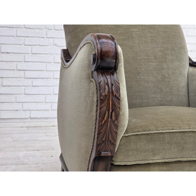 1950s, Danish relax armchair. Green furniture velour, carved oak wood, brass springs in the seat. Chair was reupholstered...