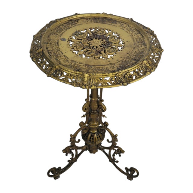 An ornate cast-iron side table in the Historicist style, made in Germany around 1880. The circular top is richly decorated...